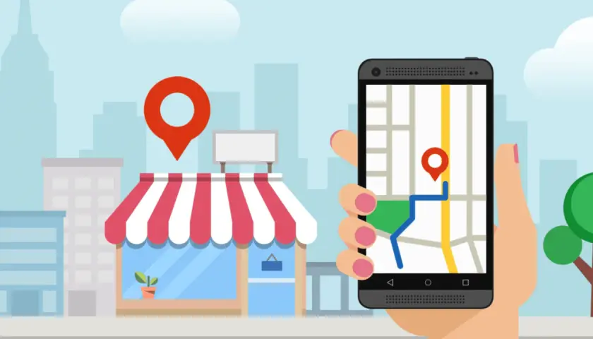 Smartfon z mapą i pinezką pokazuje drogę do sklepu. To klucz do skutecznego pozycjonowania lokalnego.
